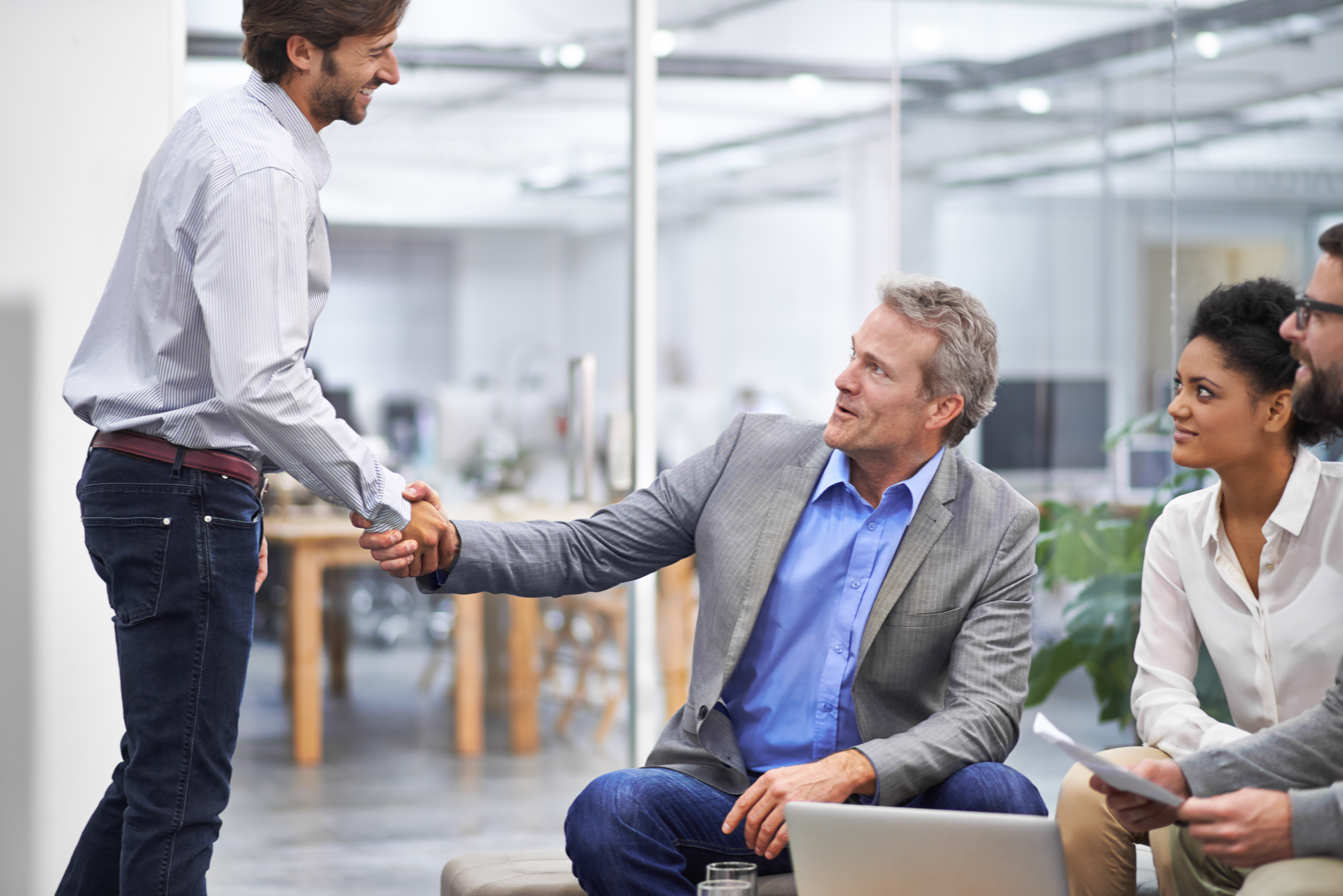 Employer extending a hand to a new employee